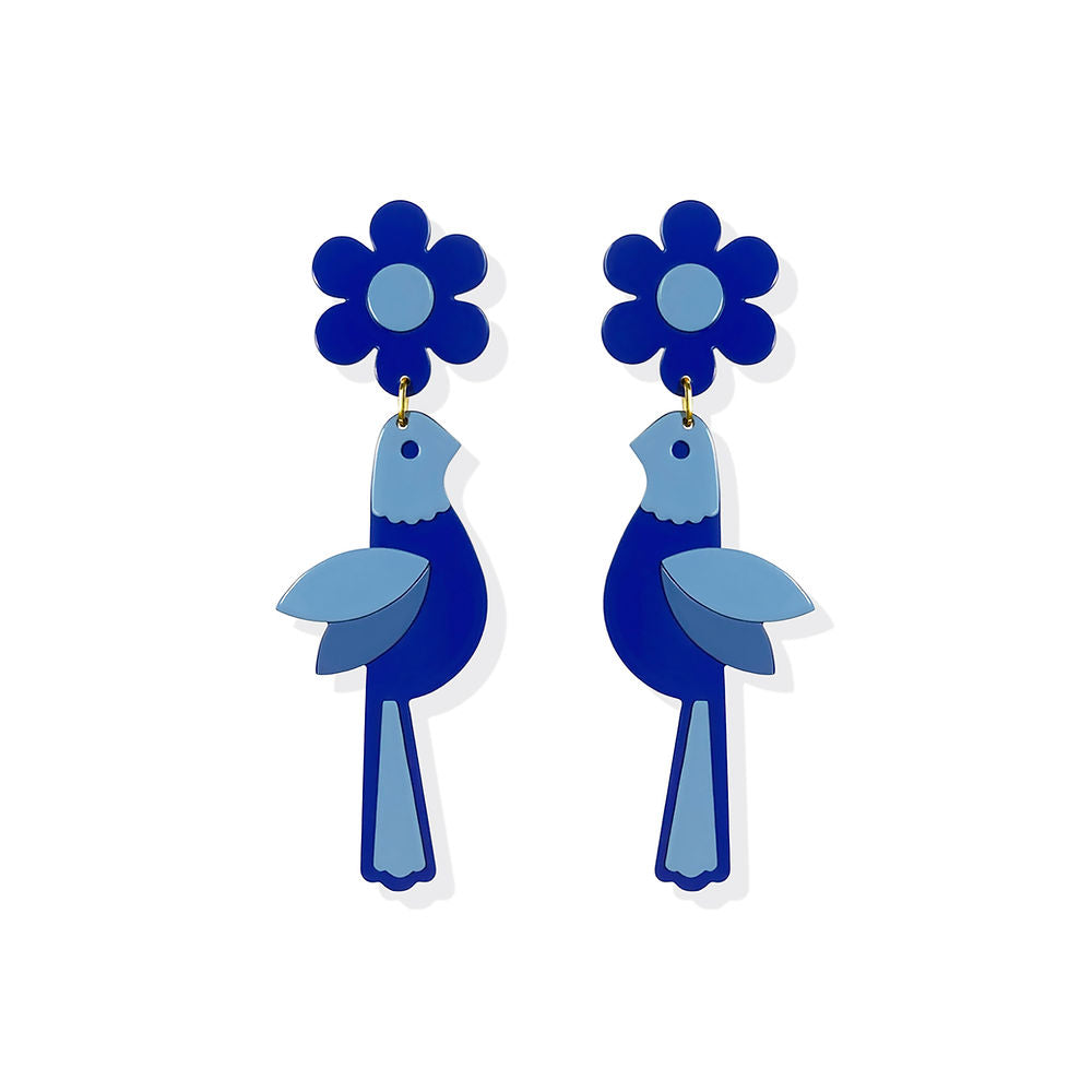 Pair of bird-shaped statement earrings in two shades of blue with matching floral tops, displayed on a white background – handmade sculptural design by ISUWA.
