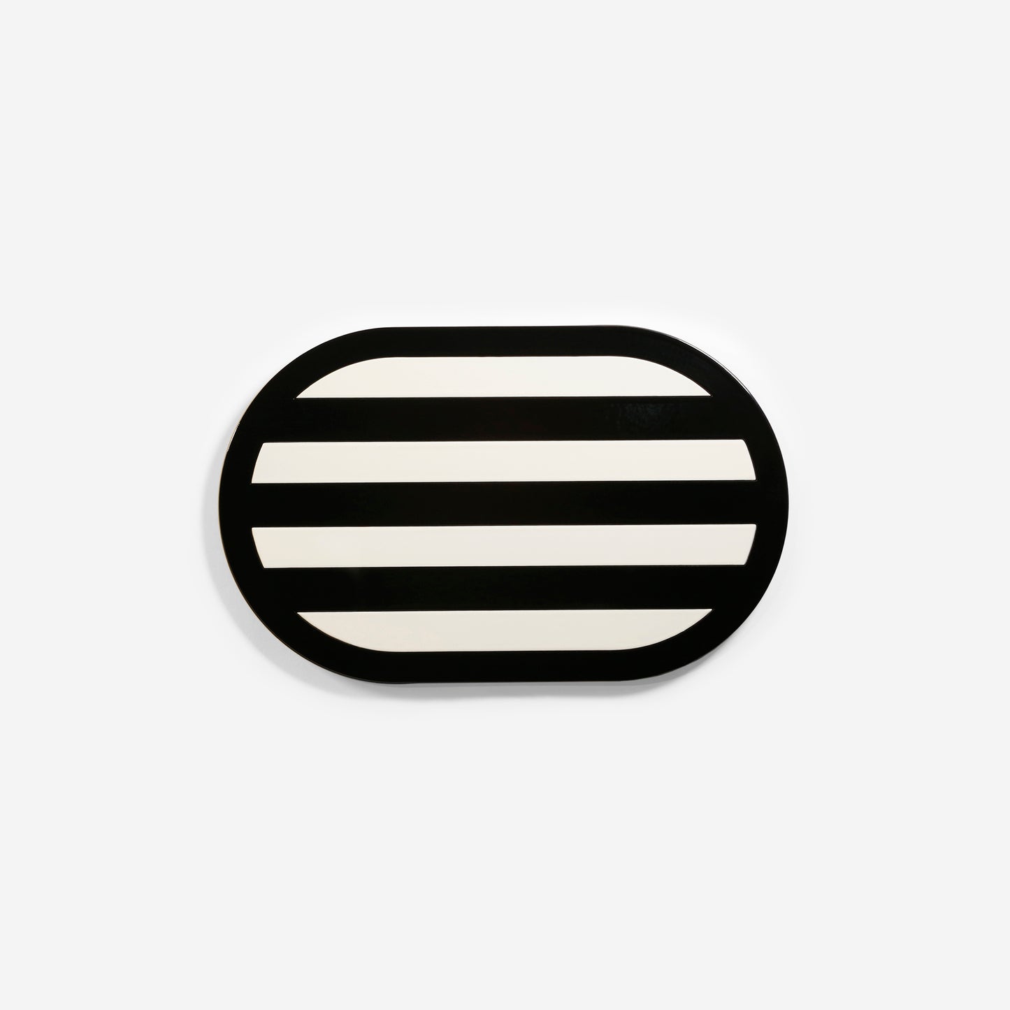 Premium black oval metal coaster with elegant striped design and glossy finish – handcrafted tableware by ISUWA for sophisticated table styling