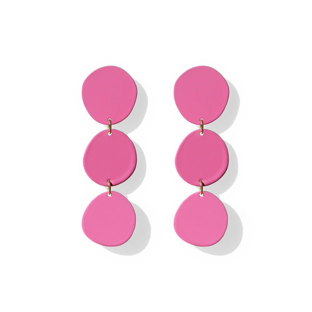Pair of pink blob-shaped earrings with three organic circular segments, arranged vertically on white background.

