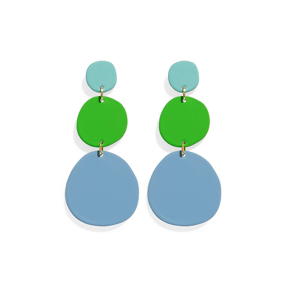 A pair of dangling earrings composed of three rounded shapes in turquoise, green and sky blue. Modern and sculptural design with a playful, colorful aesthetic, photographed on a white background.

