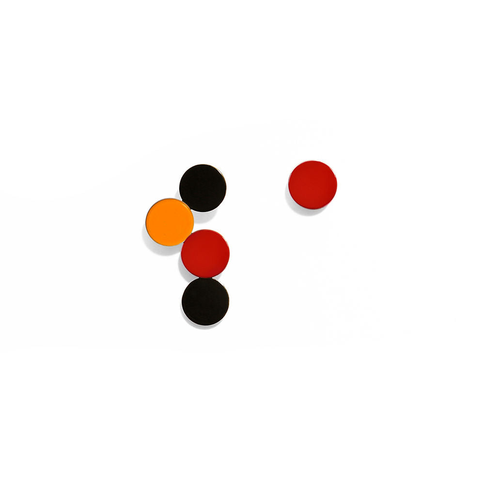 Geometric bubble earrings featuring black, red and yellow circular shapes in a bold sculptural design by ISUWA, photographed on a gray background.
