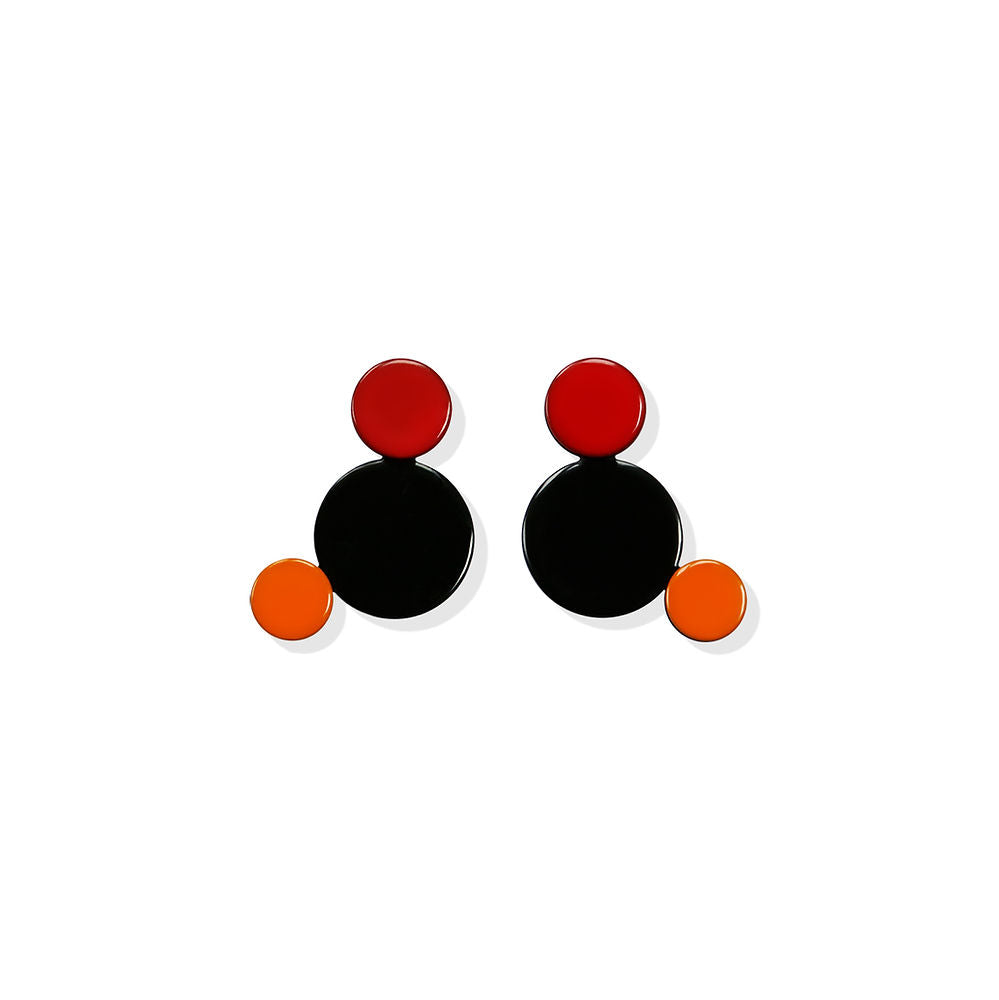 Pair of sculptural bubble earrings with black, red, and orange circular elements arranged in a playful layout, displayed on a white background.