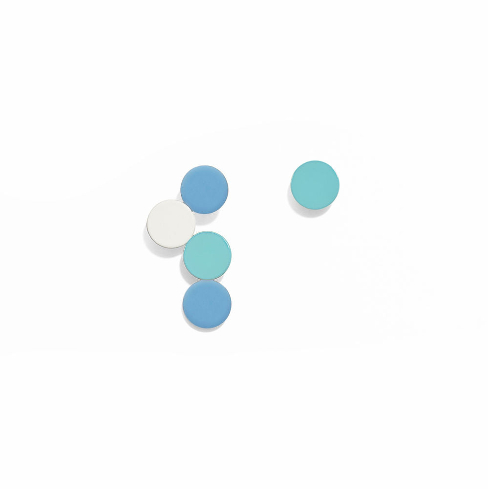 A pair of sculptural earrings featuring circular elements in shades of blue and white, arranged in a playful bubble-like composition. Displayed on a white background with a glossy finish.
