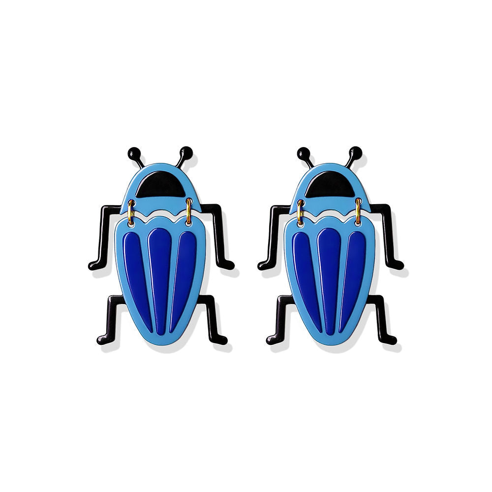 Sculptural blue and black bug-shaped earrings with playful legs and glossy finish, designed by ISUWA and photographed on a white background.

