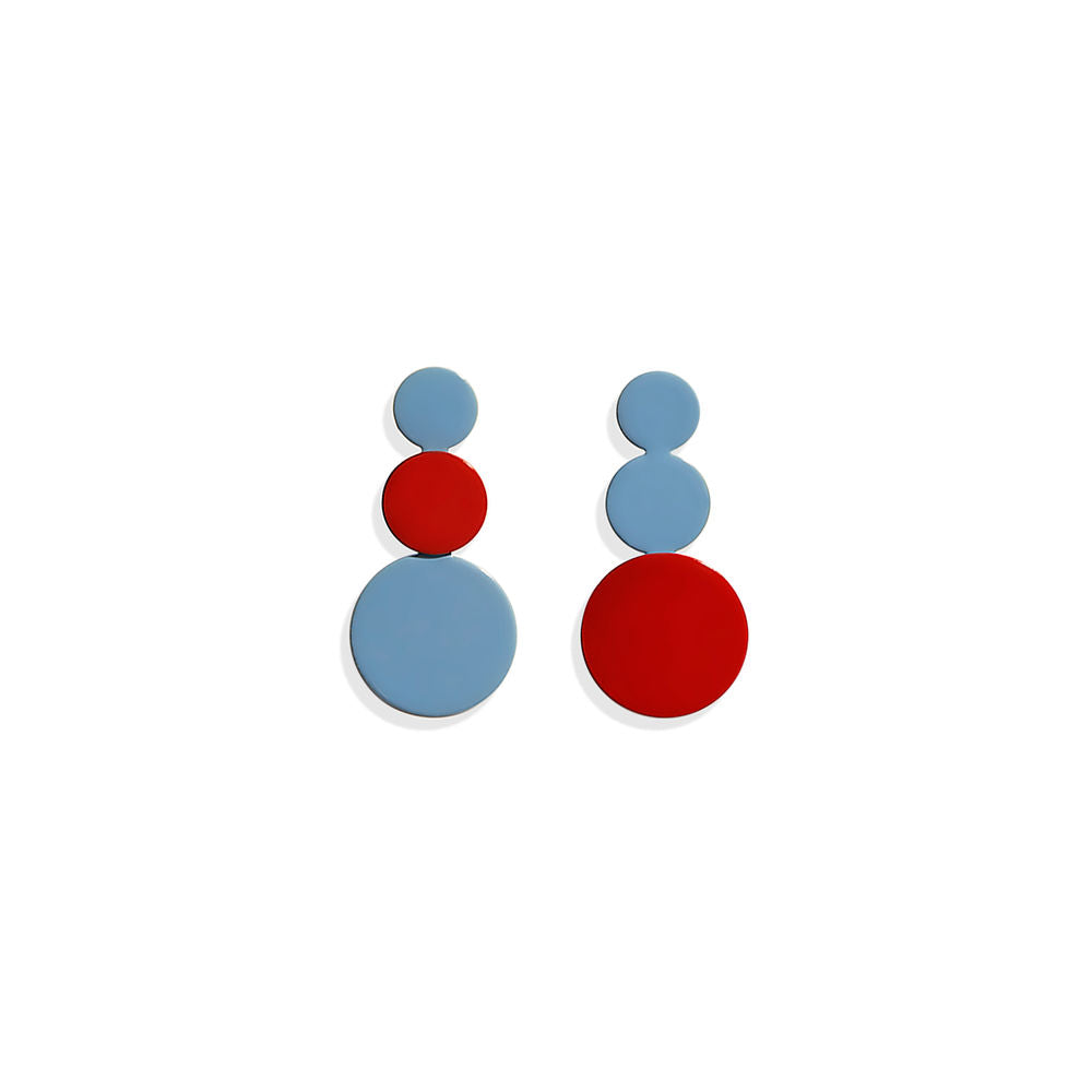 Pair of stacked circle earrings in red and blue with a sculptural cluster design, displayed on a white background.