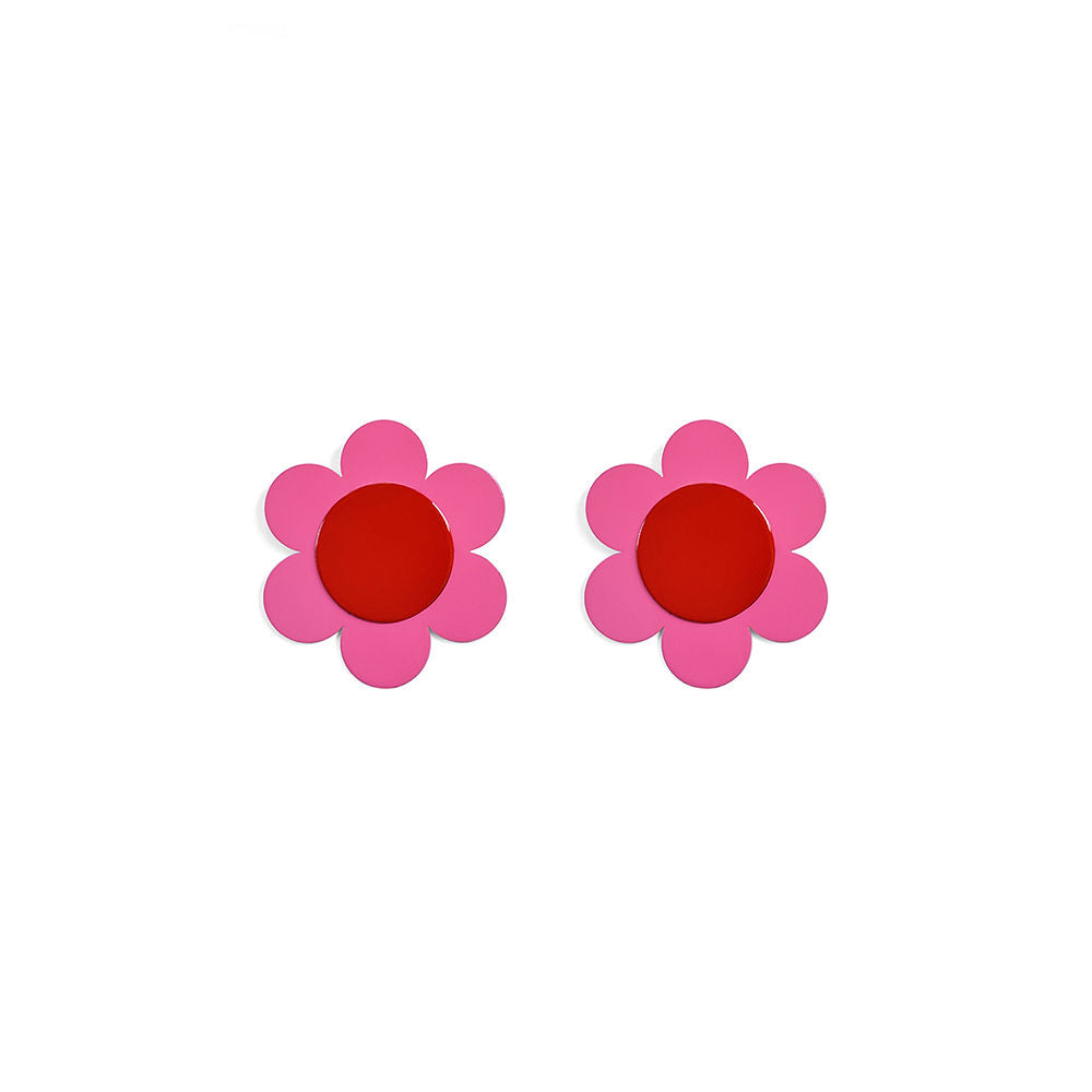 A pair of flower-shaped stud earrings with bright red circular centers and five rounded pink petals. Bold and playful floral design, photographed on a white background.
