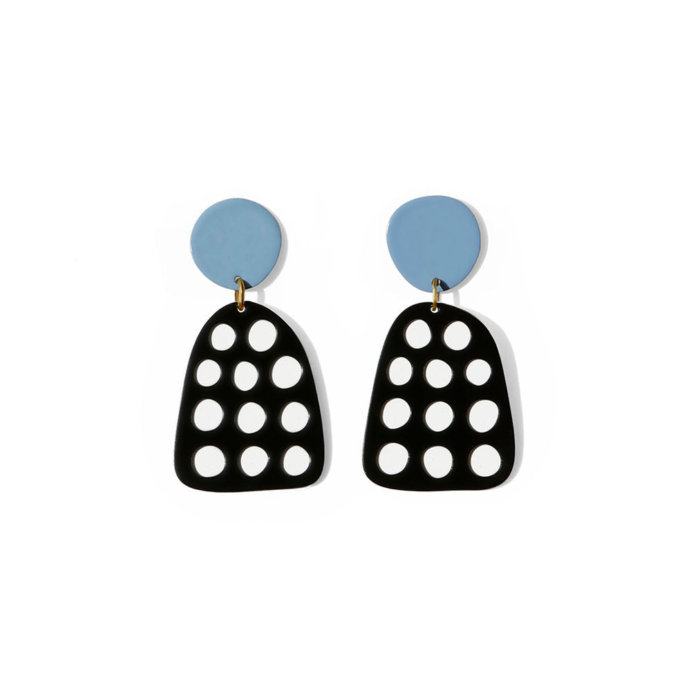 Pair of sculptural black earrings with multiple cut-out dots and blue circular tops, displayed on a white background.
