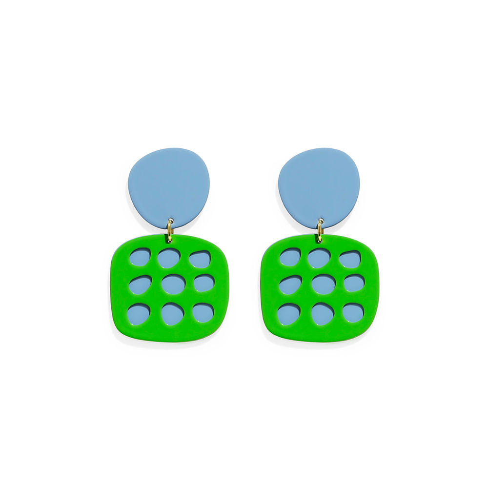 Pair of green and blue statement earrings with circular cut-outs, featuring bold sculptural shapes and glossy finish – a geometric design by ISUWA.
