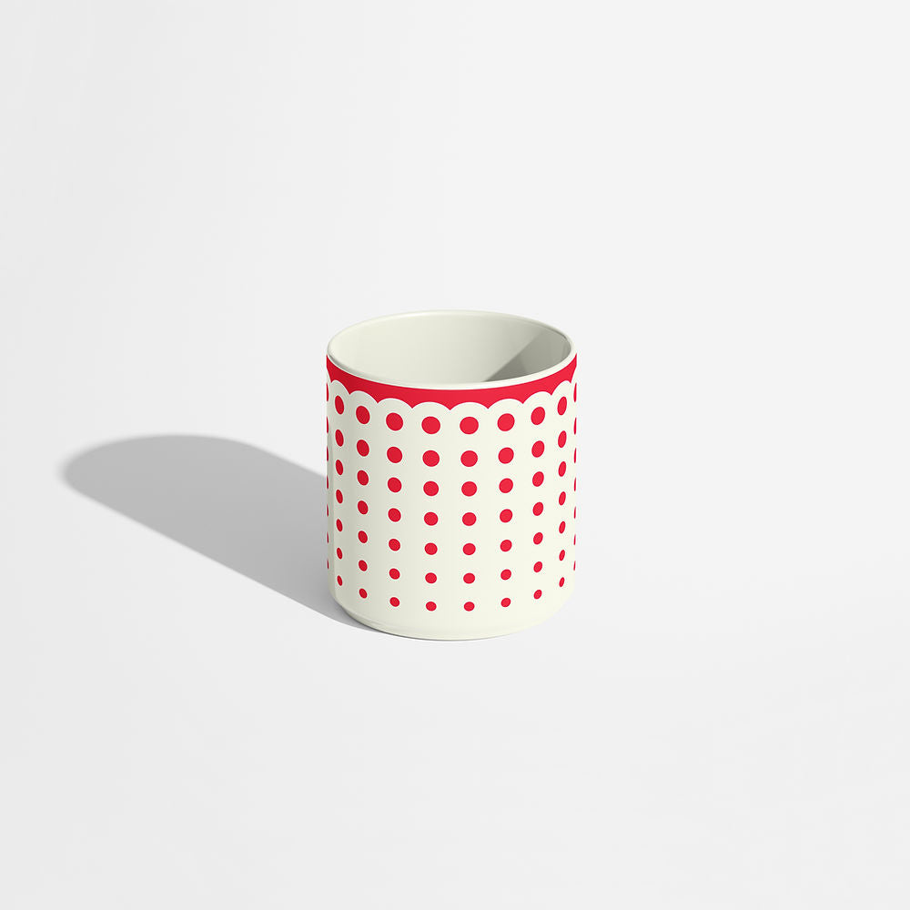 Porcelain coffee cup with a red dotted pattern and scalloped rim, designed by ISUWA and photographed on a white background.
