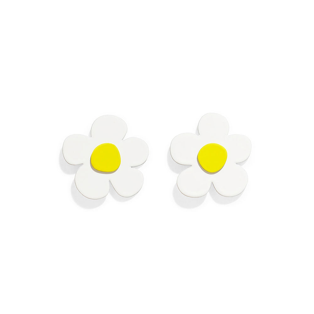 White flower-shaped earrings with a yellow center in a soft sculptural design by ISUWA, photographed on a gray background.
