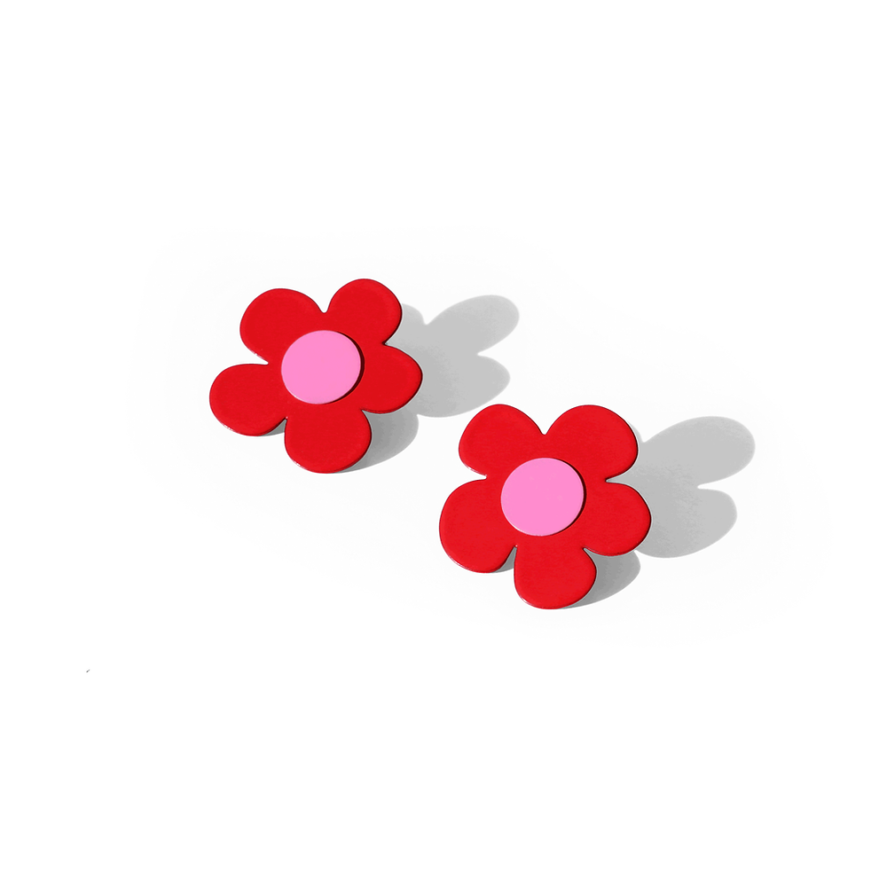 Pair of bold red flower earrings with rounded petals and light pink centers, casting soft shadows on a white background.