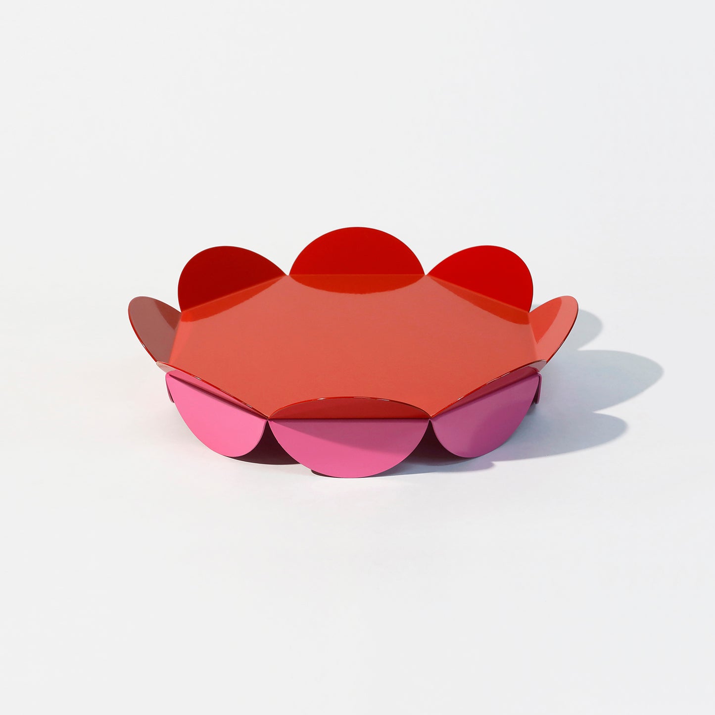 Medium red flower-shaped serving stand with petal-like edges and pink base – bold and sculptural centerpiece by ISUWA

