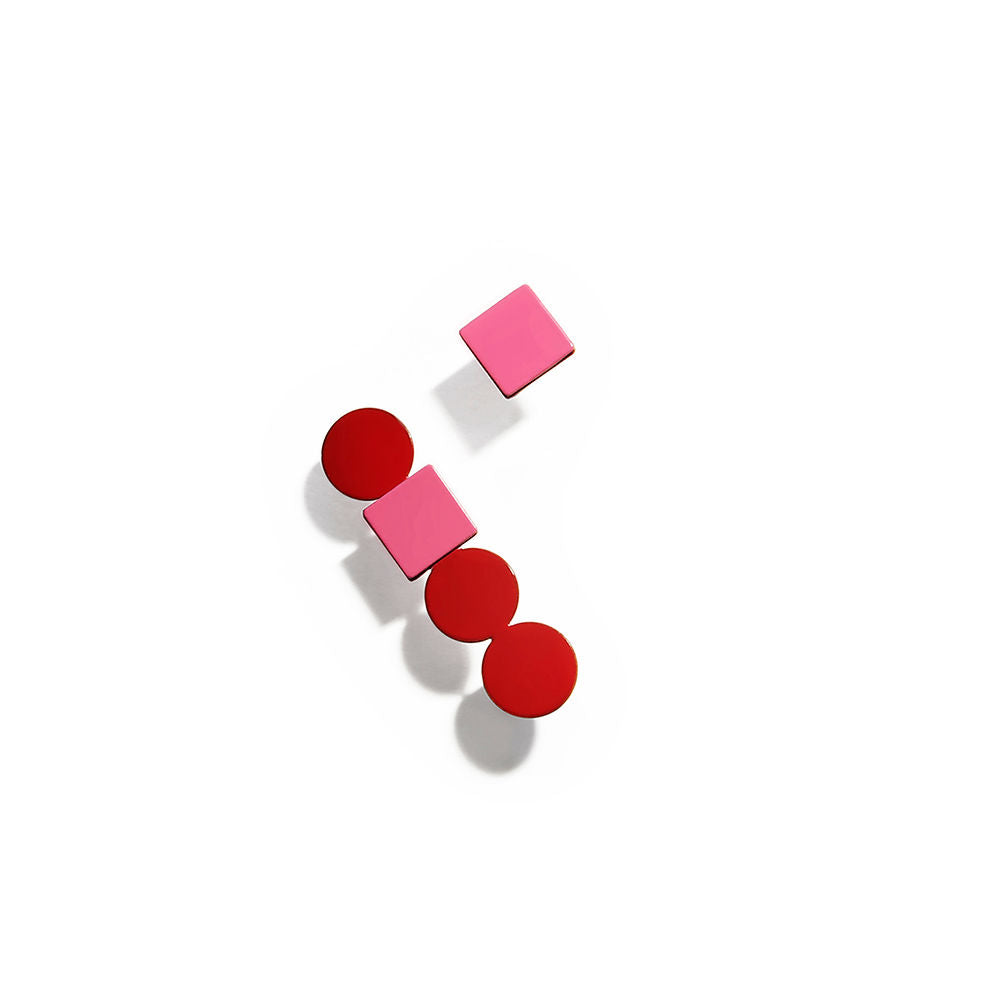 Pair of red and pink geometric earrings with stacked circles and squares in a vertical layout, displayed on a white background.
