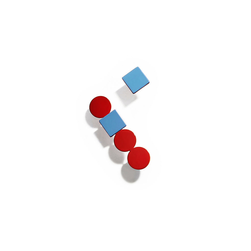 Pair of red and blue geometric earrings with stacked circles and squares in a vertical layout, displayed on a white background