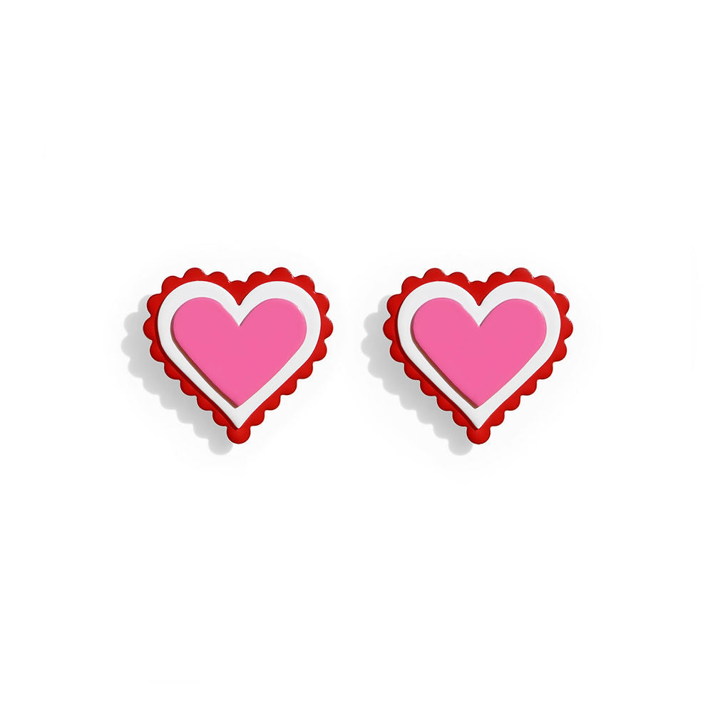 Pair of heart-shaped earrings with layered pink centers, white outlines and scalloped red edges, displayed on a white background.
