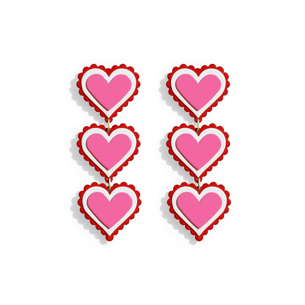Pair of long statement earrings with three stacked pink hearts, white outlines and scalloped red edges, displayed on a white background.
