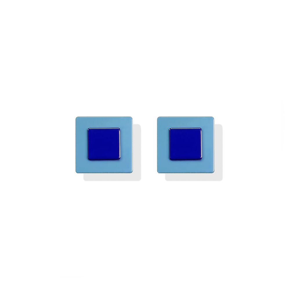 Mini square earrings with a navy blue center framed by light blue, designed by ISUWA and photographed on a white background.
