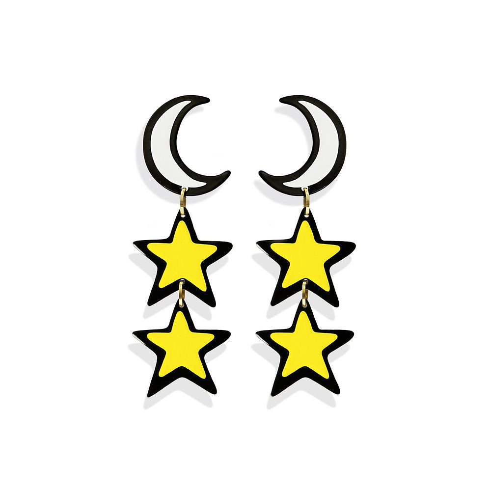 A pair of sculptural earrings featuring black crescent moons and dangling double yellow stars with bold black outlines. Displayed on a white background with a glossy finish.
