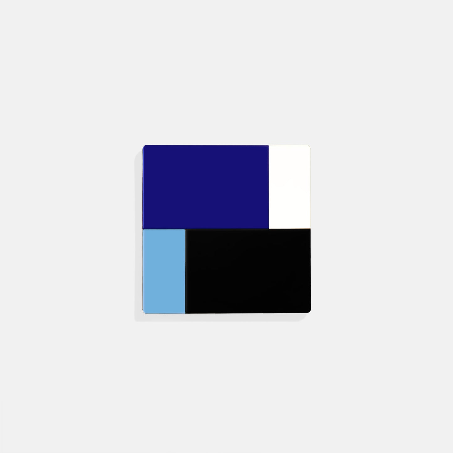Blue square metal coaster with cobalt, sky blue, white and black color blocks – handcrafted by ISUWA for modern geometric table styling