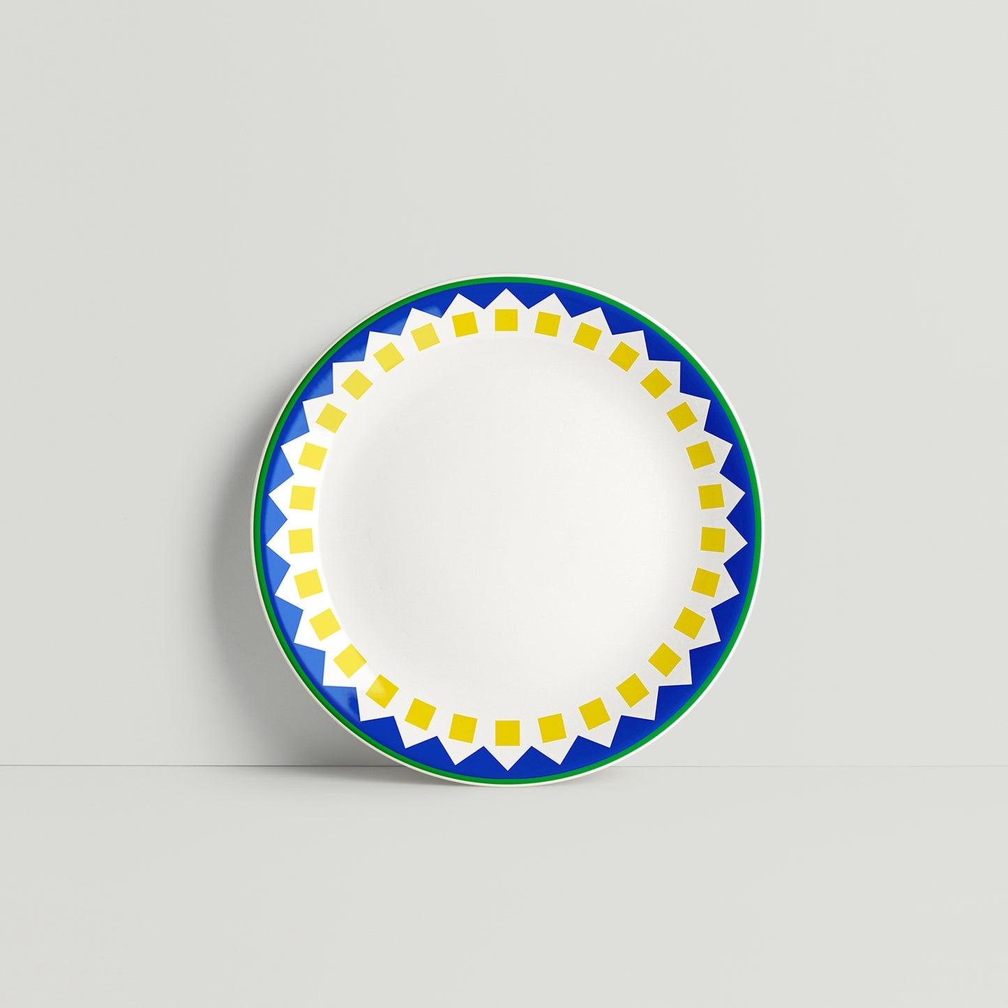 Porcelain plate with sunflower-inspired design featuring yellow square and blue zigzag border, handmade by ISUWA
