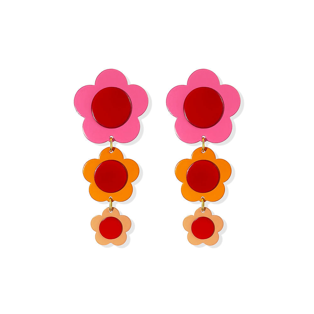 Cascading flower-shaped earrings in pink, orange and peach with red centers, designed by ISUWA and photographed on a white background.
