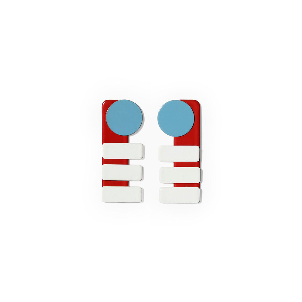 Pair of rectangular earrings with blue circles, red bases, and three stacked white bars, displayed on a white background.