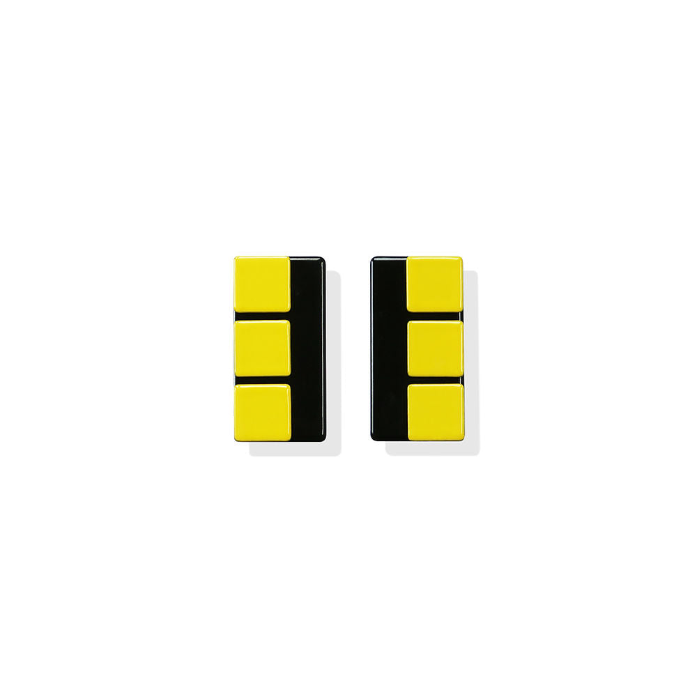 Geometric rectangle earrings in yellow and black with a modern, minimalist design by ISUWA, photographed on a white background.
