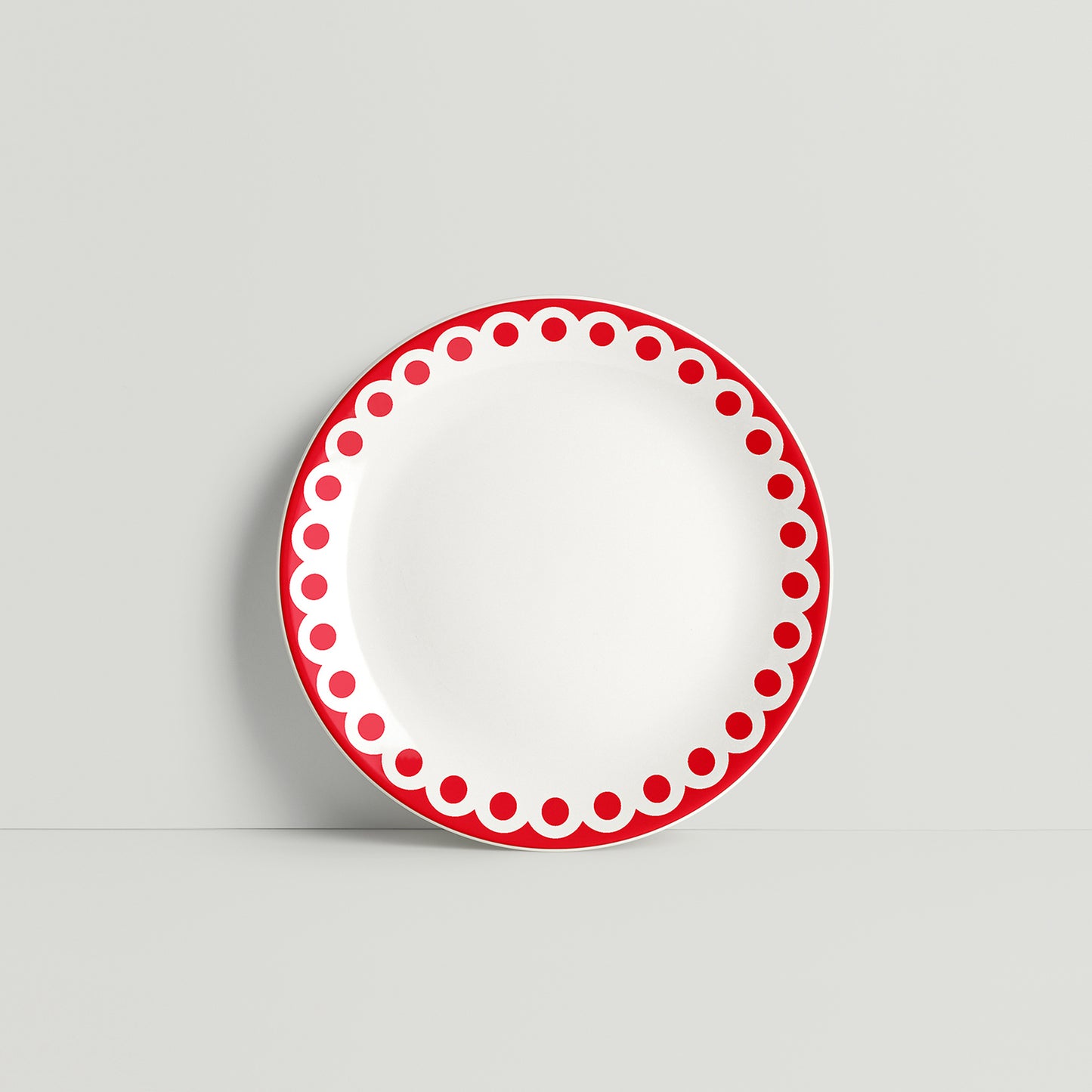 Porcelain plate with bold red dotted rim, modern and playful handmade design by ISUWA