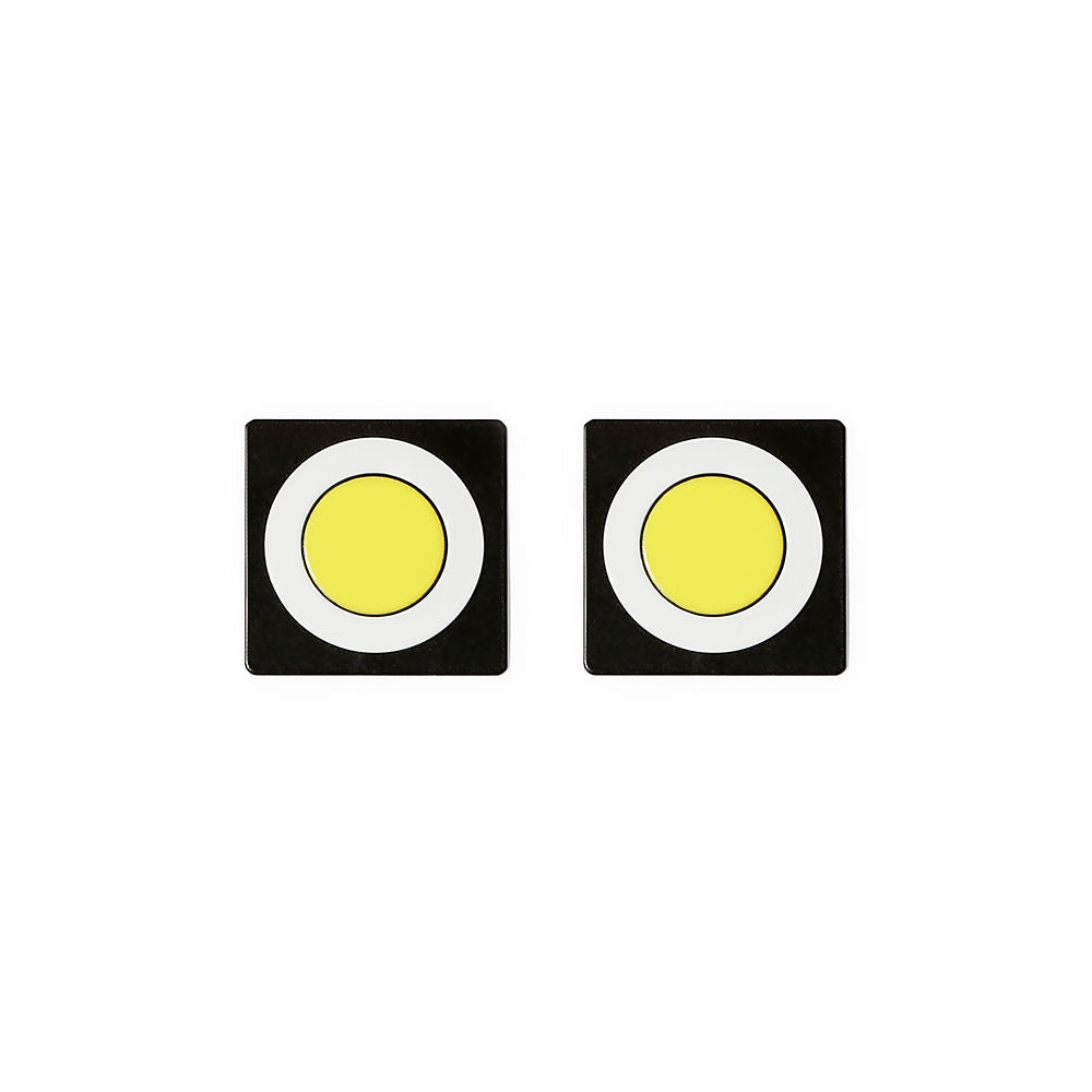 A pair of square stud earrings with a bold circular design. Each earring features a yellow circle in the center, surrounded by a white ring and set on a black square base. Clean, modern, and high-contrast look, photographed on a white background.
