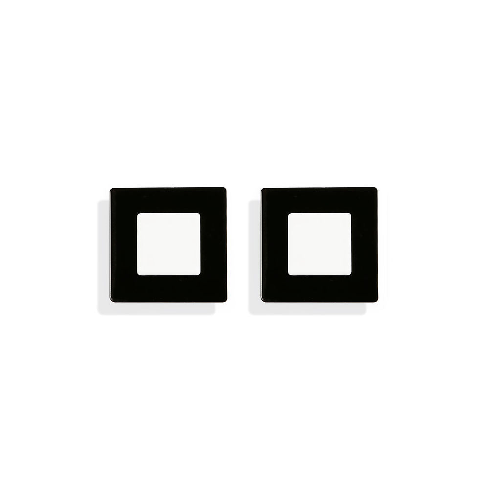 Square-shaped earrings with a white center framed in matte black, designed by ISUWA and photographed on a neutral background.
