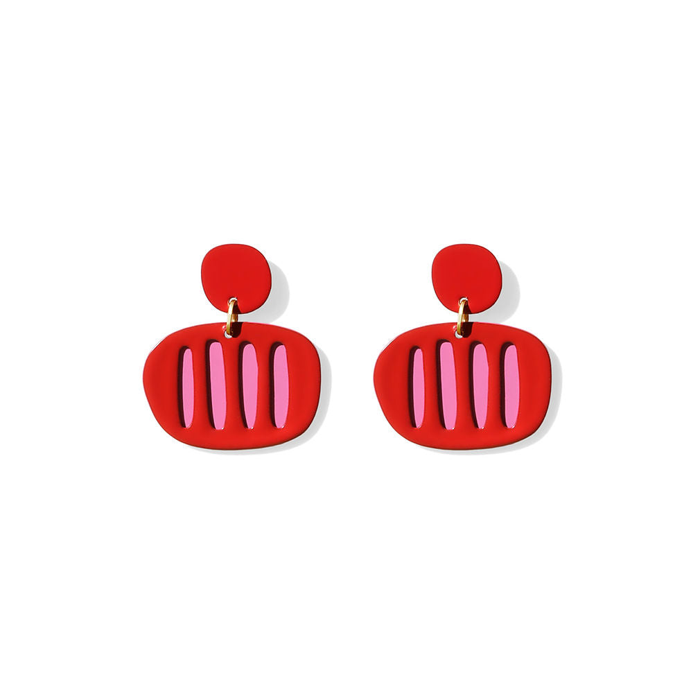 Sculptural red earrings with pink vertical stripes and a rounded silhouette, designed by ISUWA and photographed on a white background.
