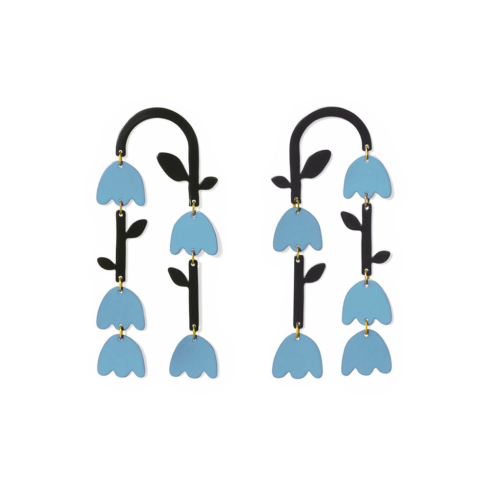 Long statement earrings featuring layered blue tulip shapes with black curved tops and green leafy stems, designed by ISUWA with a bold and artistic flair.
