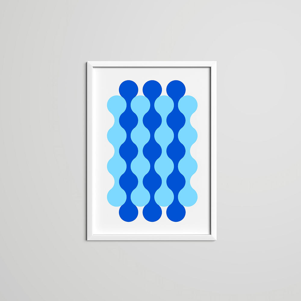 Waves Art Print – Blue: A bold geometric wall art piece featuring wavy vertical patterns in two shades of blue, printed on white background with a modern white frame.
