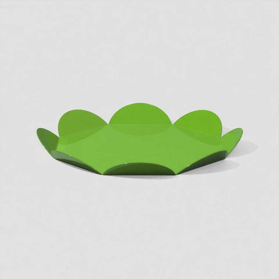 A rotating green flower-shaped metal tray with glossy finish. The video reveals the sculptural petal edges and reflective surface as it turns on a white background.
