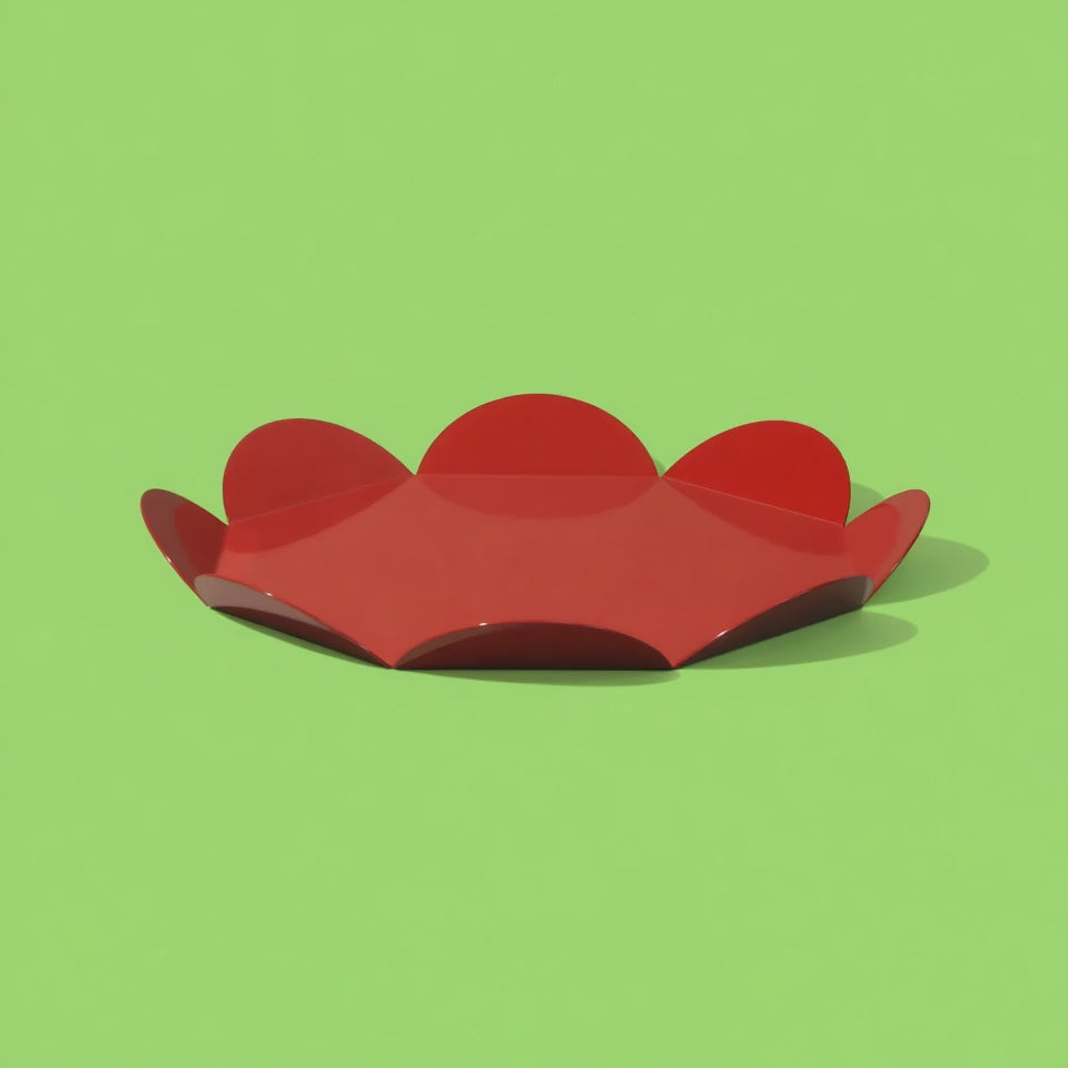 A rotating red flower-shaped metal tray with glossy finish, set against a light green background. The video highlights the tray’s sculptural petal edges and shiny surface from different angles.
